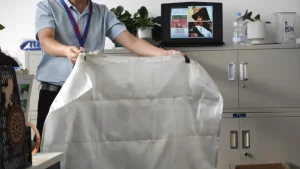 Fire Blanket Demonstration Fire blanket being unfolded during a fire safety demonstration for emergency fire suppression in industrial workplaces